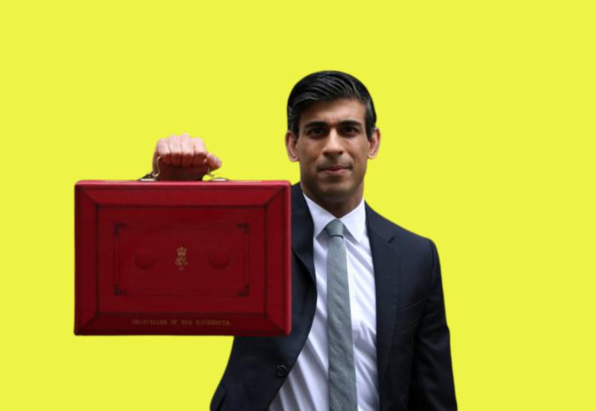 An Asian man wearing a suit and tie holding up a red box against a yellow background.