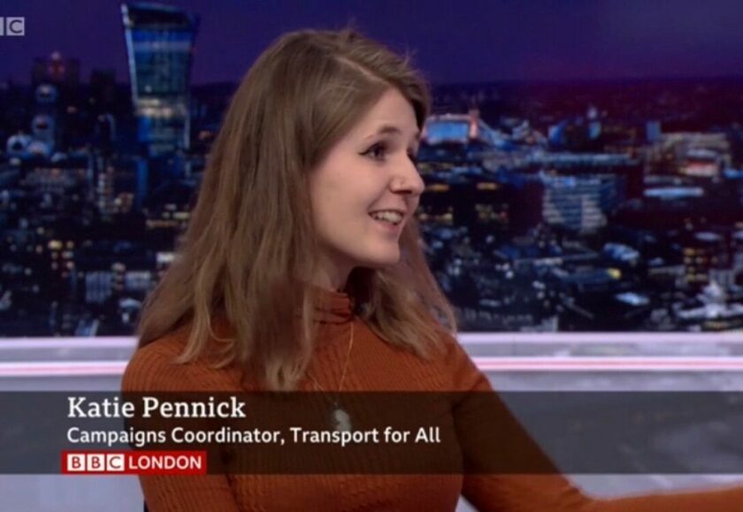 Katie, a white woman with brown hair, in mid-sentence, on BBC London news. There is an aston at the bottom of the screen reading 'Katie Pennick, Campaigns Coordinator, Transport For All'.