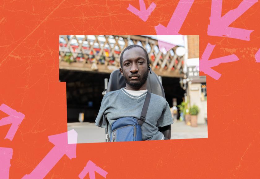 A Black man with upper and lower limb differences stares into the camera. Behind him is a railway bridge with a train moving across it. Image is on a hot orange background with pink arrows fashioned out of electrical tape pointing at Isaac.